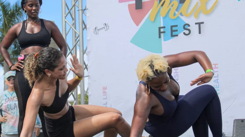 Coach demonstrates animal flow on stage at FITMIX FEST