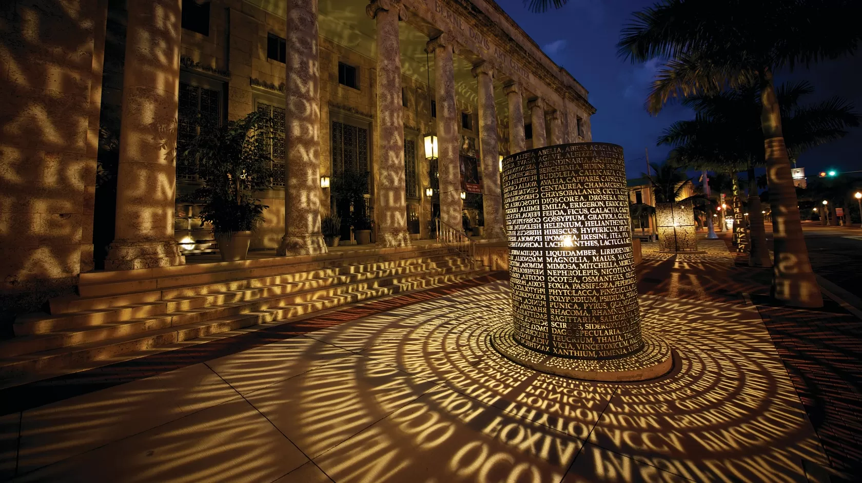 manuscripts sculpture at sidney berne davis art center lit up at night