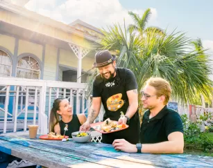 David Acevedo, artist and co-owner of Arts & Eats Café serves guests of his cafe